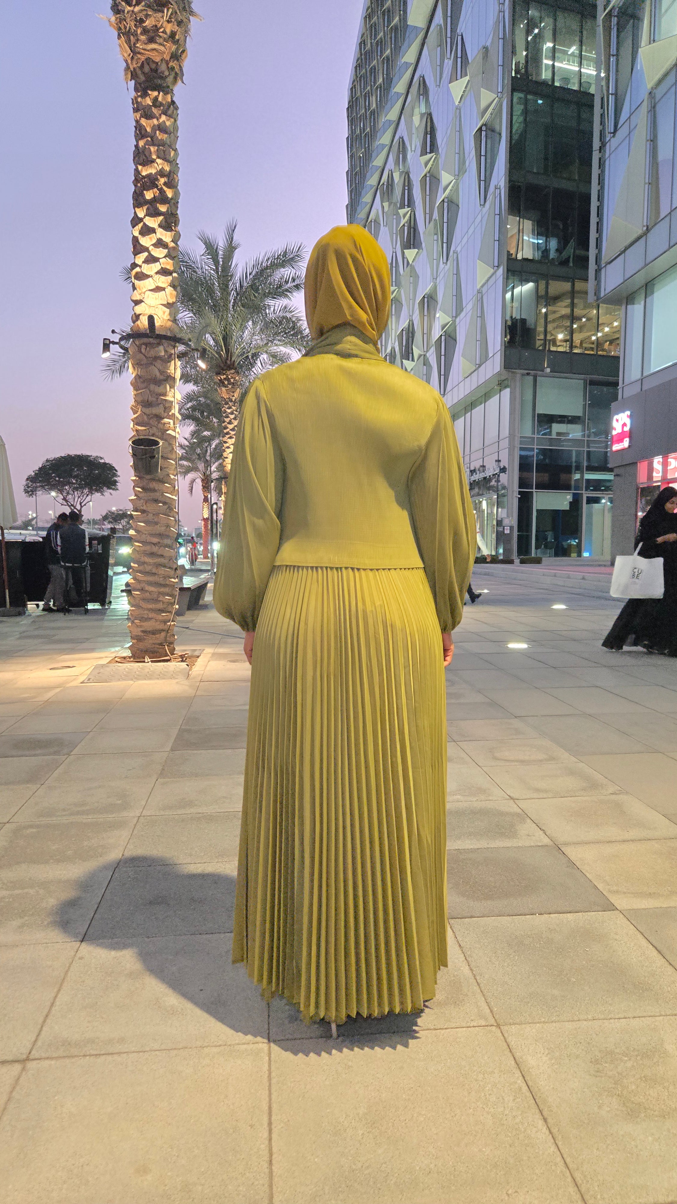 Olive Aura Plissé Abaya in moss green with balloon sleeves and micro-pleated fabric